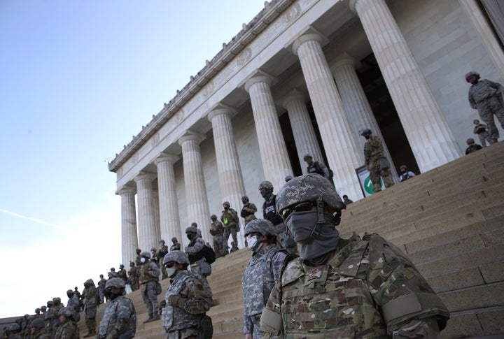 Members of the DC National Guard stand on the steps of the Lincoln Memorial as demonstrators participate in a peaceful protest against police brutality and the death of George Floyd.