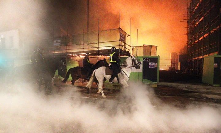 Police on horseback during the first night of the riots in Tottenham.