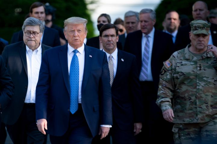President Donald Trump pictured walking Attorney General William Barr, Defense Secretary Mark Esper and Chairman of the Joint Chiefs of Staff Mark Milley from the White House to visit St. John's Church after the area was cleared of people protesting the death of George Floyd.