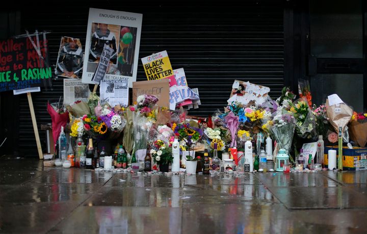 Floral tributes and candles in east London following the death of Rashan Charles