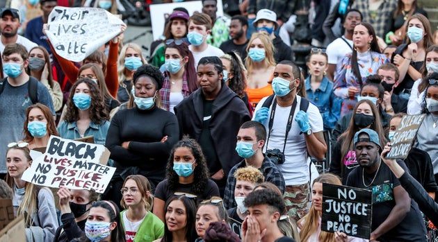 People participate in a Black Lives Matter protest rally outside the St George's Hall in Liverpool, in memory of George Floyd who was killed on May 25 while in police custody in the US city of Minneapolis.