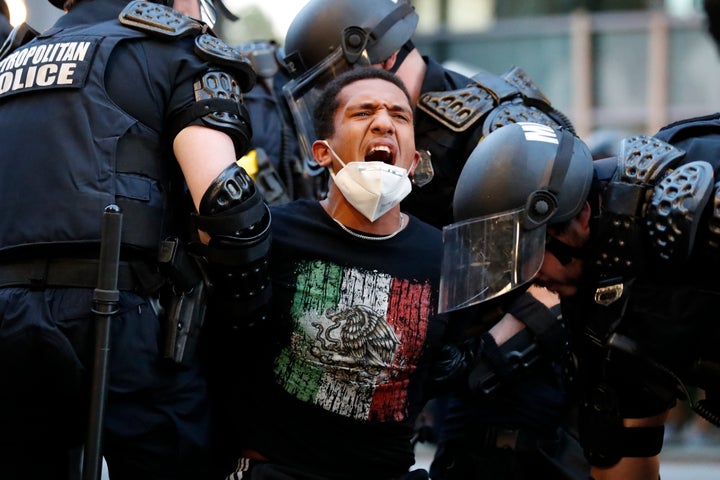 A demonstrator is taken into custody by police near the White House in Washington after a curfew took effect on June 1.