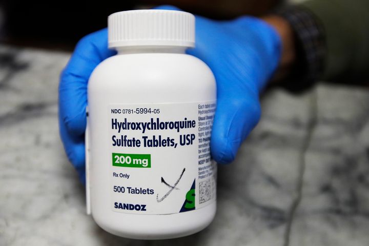 In this April 6, 2020 file photo, a pharmacist holds a bottle of the drug hydroxychloroquine in Oakland, Calif. Results published Wednesday, June 3, 2020, by the New England Journal of Medicine show that hydroxychloroquine was no better than placebo pills at preventing illness from the COVID-19 coronavirus. The drug did not seem to cause serious harm, though - about 40% on it had side effects, mostly mild stomach problems. (AP Photo/Ben Margot)