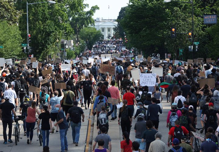 Hundreds of demonstrators march toward Lafayette Park and the White House to protest against police brutality and the death of George Floyd on Monday.