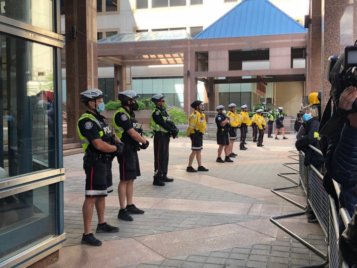 Toronto police line barricade their headquarters in downtown Toronto during protests over the death of Regis Korchinski-Paquet on May 30, 2020.
