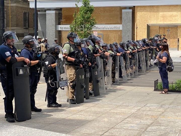 Members of federal law enforcement line up with riot gear and face shields near the White House on Wednesday.