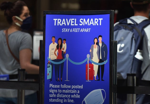A sign reminding passengers to stay six feet apart is seen at a screening checkpoint at Orlando International