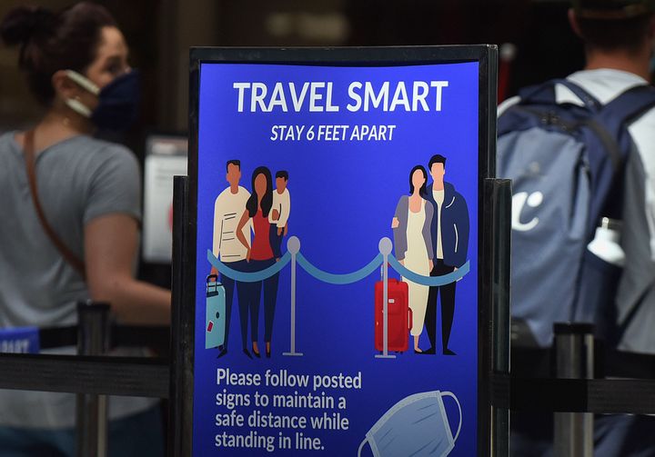 A sign reminding passengers to stay six feet apart is seen at a screening checkpoint at Orlando International Airport. 