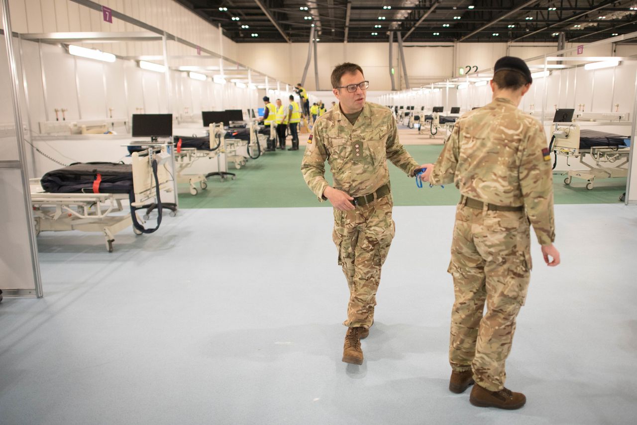 Military personnel, pictured at the ExCel centre in London, also worked on the Nightingale hospitals