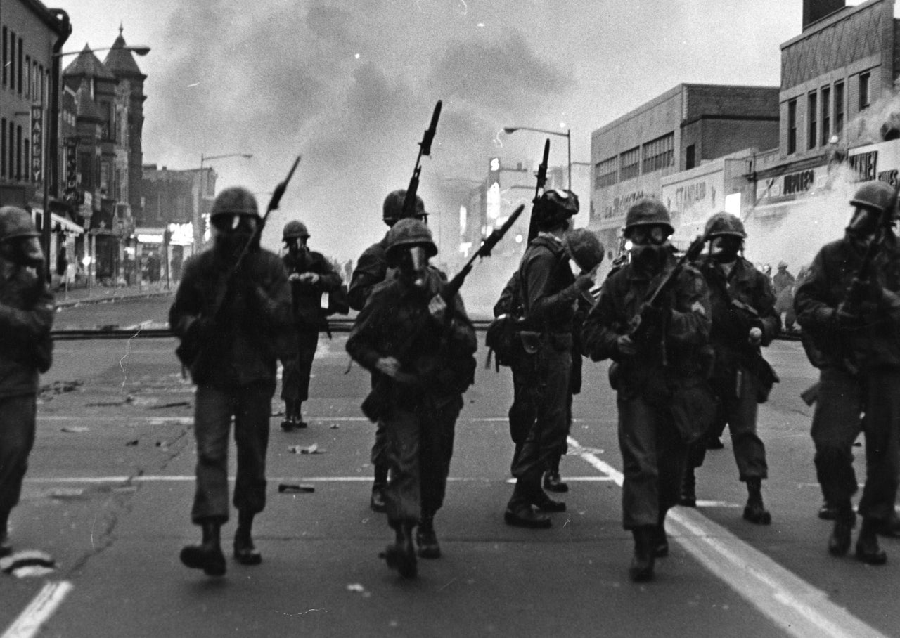 Troops march along a street in Washington in April 1968, responding to protests that turned violent following the assassination of Martin Luther King Jr. in Memphis, Tennessee. The grief and anger caused by his killing sparked tumult in cities throughout the U.S.