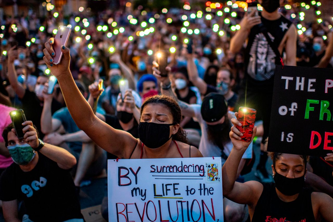 Protesters hold up their phones outside the White House on June 3 during a demonstration against police brutality and the killing of George Floyd.