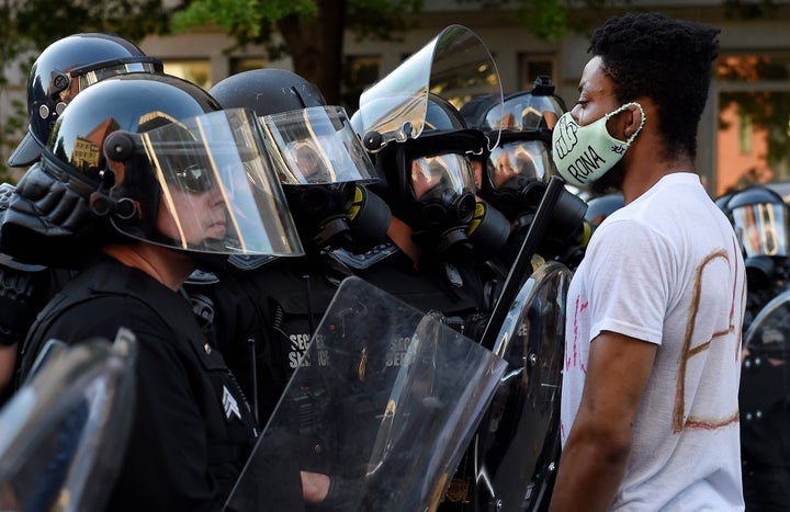 Law enforcement officers face off with demonstrators outside the White House as part of a wave of anti-racism protests nationwide.