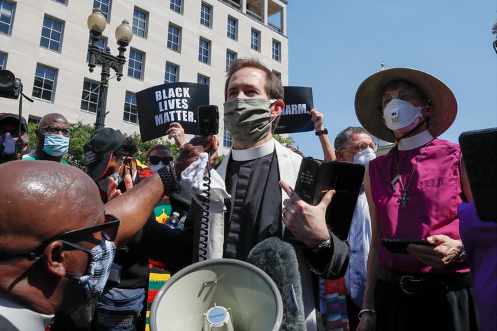 Rev. Rob Fisher, rector of St. John's Church, speaks Wednesday about a block from the church near the White House after a security perimeter prevented access to the church property itself.