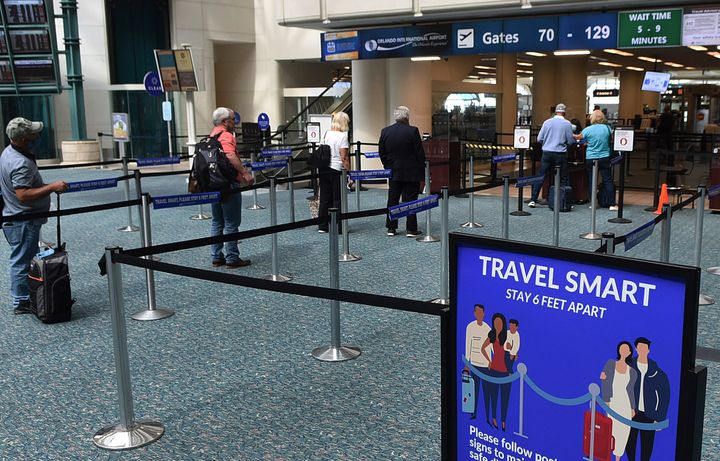 A sign reminding passengers to stay six feet apart at a screening checkpoint at Orlando International Airport on May 21, 2020.&nbsp;