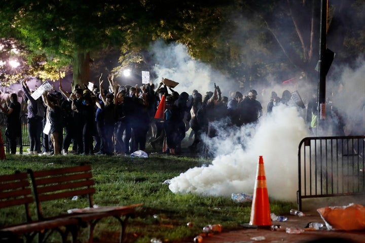 Tear gas billows as demonstrators gather in Lafayette Park to protest the death of George Floyd, Sunday, May 31, 2020, near the White House in Washington.