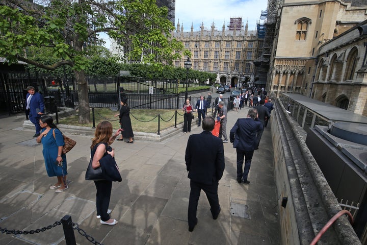 Members of Parliament queue outside the House of Commons in Westminster, London, as they wait to vote on the future of procee