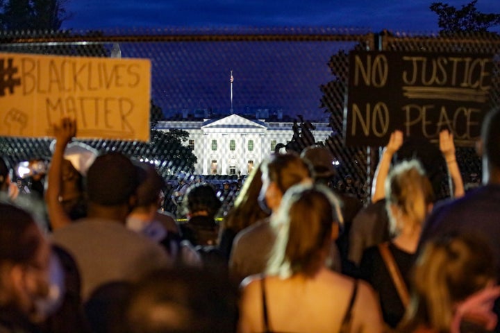 Thousands of peaceful demonstrators holding banners gather in front of the White House on June 2, 2020&nbsp;to protest the de