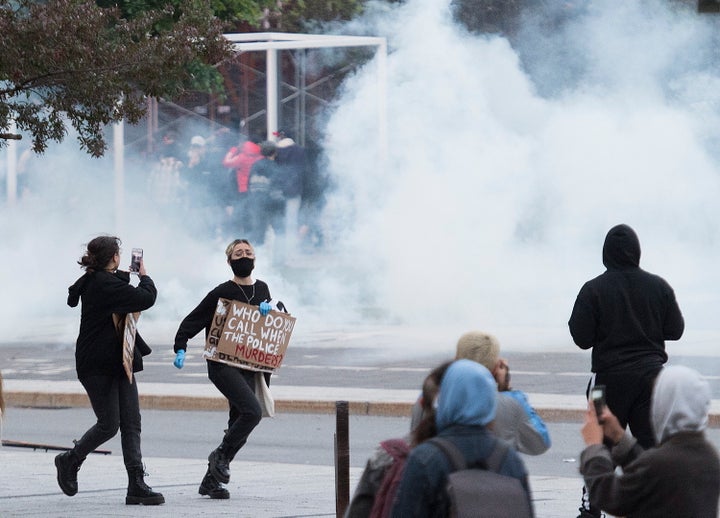 Protesters run from police during a demonstration calling for justice in the death of George Floyd and victims of police brutality in Montreal on May 31, 2020.