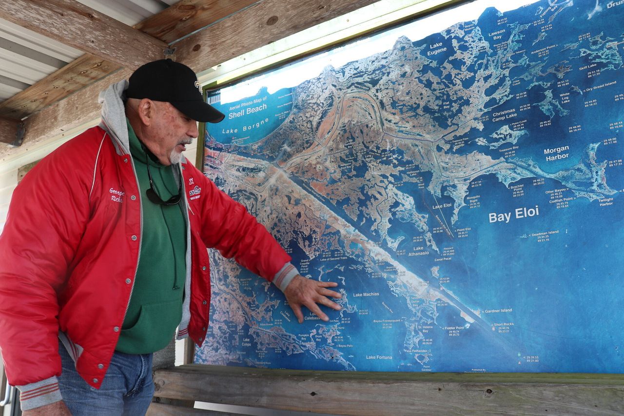 Capt. George Ricks views a map of the Louisiana bayou in St. Bernard Parish.