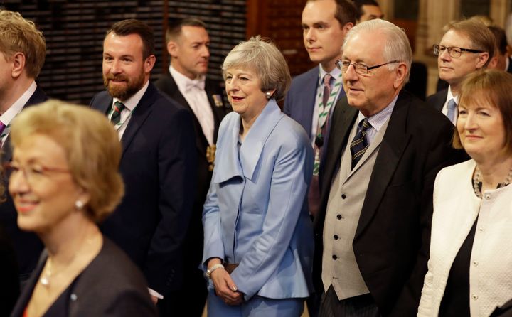 Theresa May walks with other Members of Parliament through the Commons Members Lobby to hear the Queens's Speech in Parliament in December