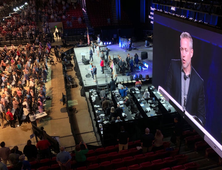 The president of the Southern Baptist Convention, J.D. Greear, is shown on a video screen as he addresses the denomination's