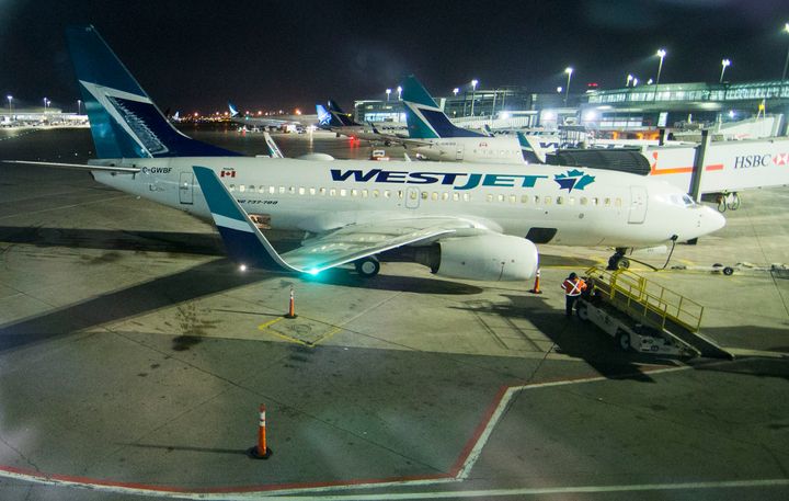 WestJet passenger planes at Lester B. Pearson International Airport in Toronto, March 24, 2020. WestJet says it will start offering cash refunds to some passengers on international flights that were cancelled due to the coronavirus.