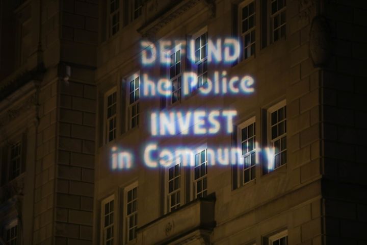 Text is projected Thursday on a building in downtown Washington during a protest over police brutality sparked by the May 25 death of George Floyd, a Black man who died after a white police officer in Minneapolis knelt on his neck.