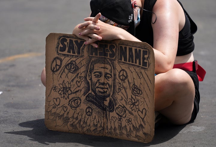 People gathered in the middle of the street at the site of George Floyd's death to listen to audio from Floyd's memorial service on June 4, 2020, in south Minneapolis.