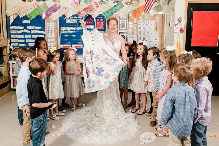 Smith shows off the dress her class made for her.&nbsp