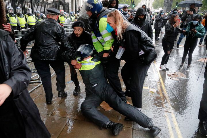 A police officer was injured when falling of a horse during scuffles with demonstrators at Downing Street.