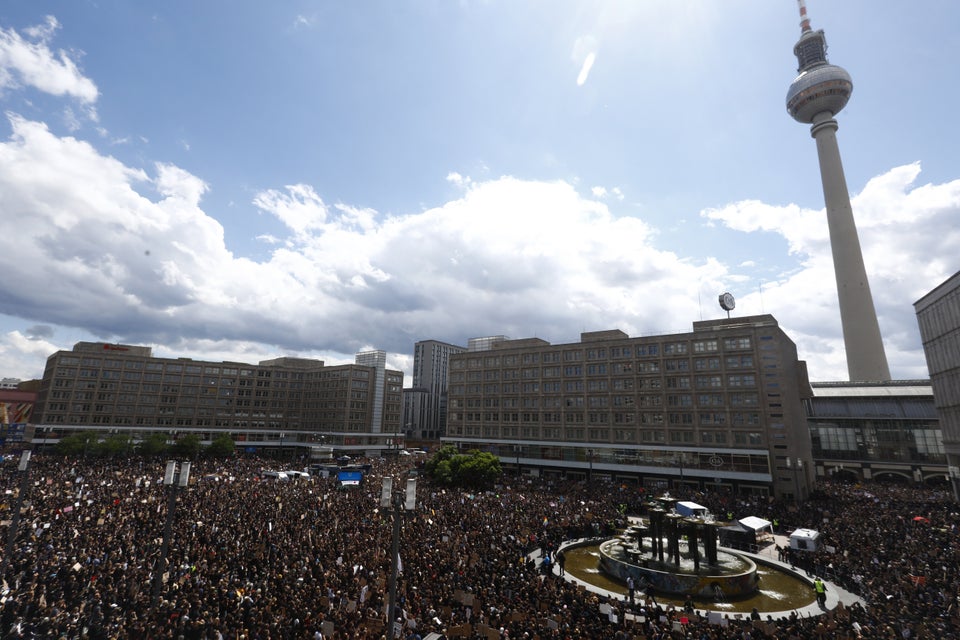 Alexanderplatz in Berlin, Germany, is seen fully crowded with people holding banners and placards as they stand in silence for eight minutes and 46 seconds in tribute to George Floyd.