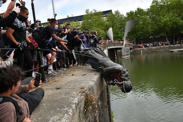 Protesters throw statue of Edward Colston into Bristol harbour during a Black Lives Matter protest in Bristol on Sunday.