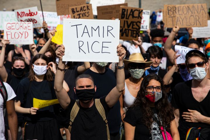 A protester in New York holds up a sign bearing Tamir Rice's name at a protest on May 29, 2020, following George Floyd's death.