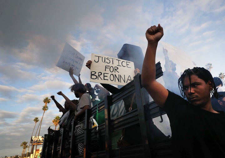 Protesters demonstrate against racism in Los Angeles on Sunday. One protester is holding a sign "Justice for Breonna."