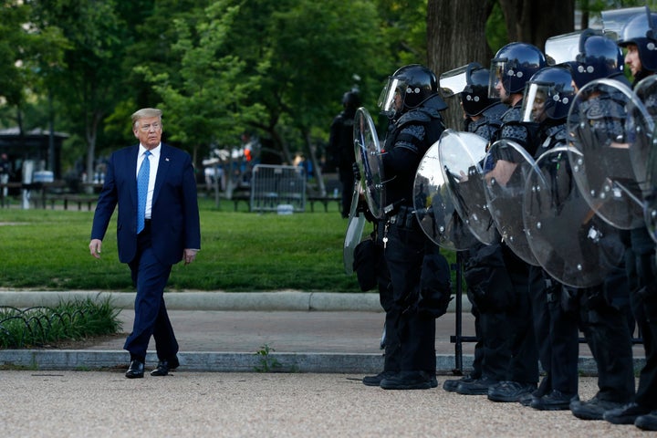 President Donald Trump walks past police in Lafayette Park after visiting St. John's Church across from the White House on Monday, June 1 in Washington.