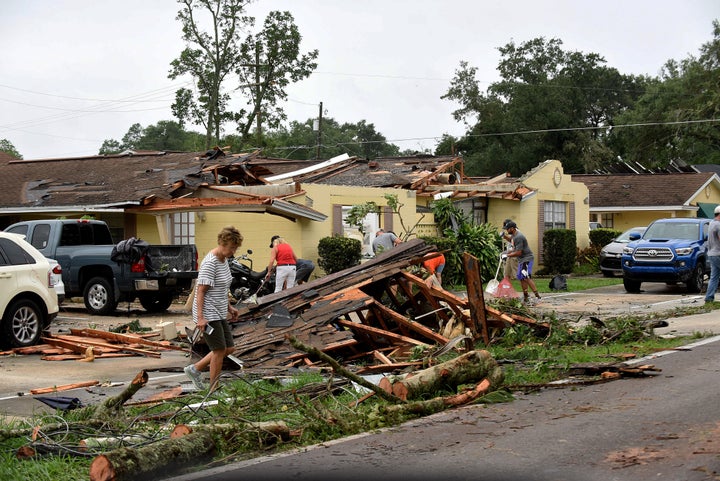 People clean up debris from their damaged apartments during the aftermath of Tropical Storm Cristobal. 