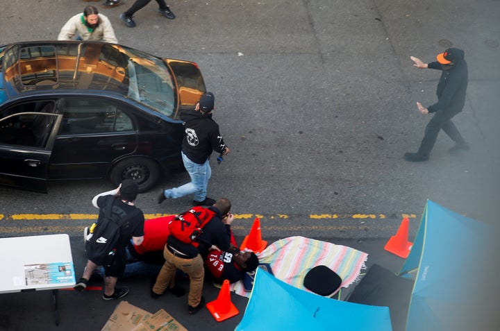 A man carries a gun after trying to drive through a crowd and shooting a man in the arm during a protest against racial inequality in the aftermath of the death in Minneapolis police custody of George Floyd, in Seattle, Washington, U.S. June 7, 2020. REUTERS/Lindsey Wasson