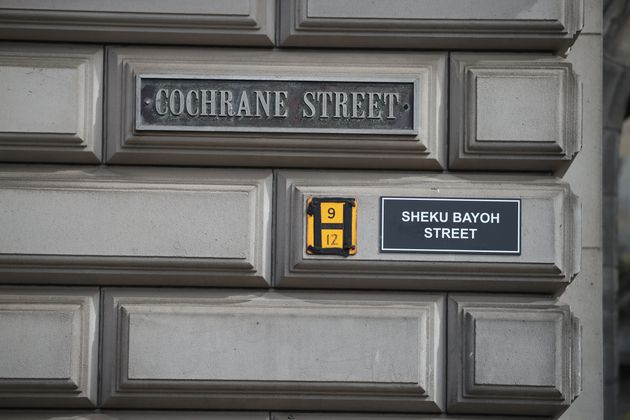 A sign alternatively naming Cochrane Street 'Sheku Bayoh Street' in Glasgow. 