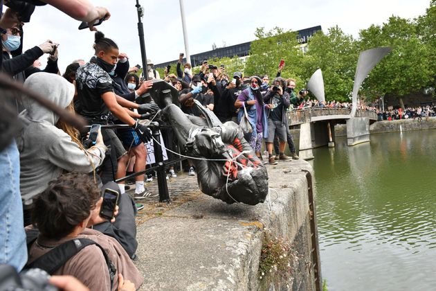 Protesters throw a statue of slave trader Edward Colston into Bristol harbour