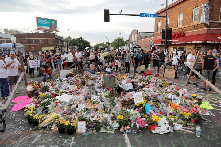 People gather around a makeshift memorial for George Floyd, Wednesday, June 3, 2020, in Minneapolis. (AP Photo/Julio Cortez)