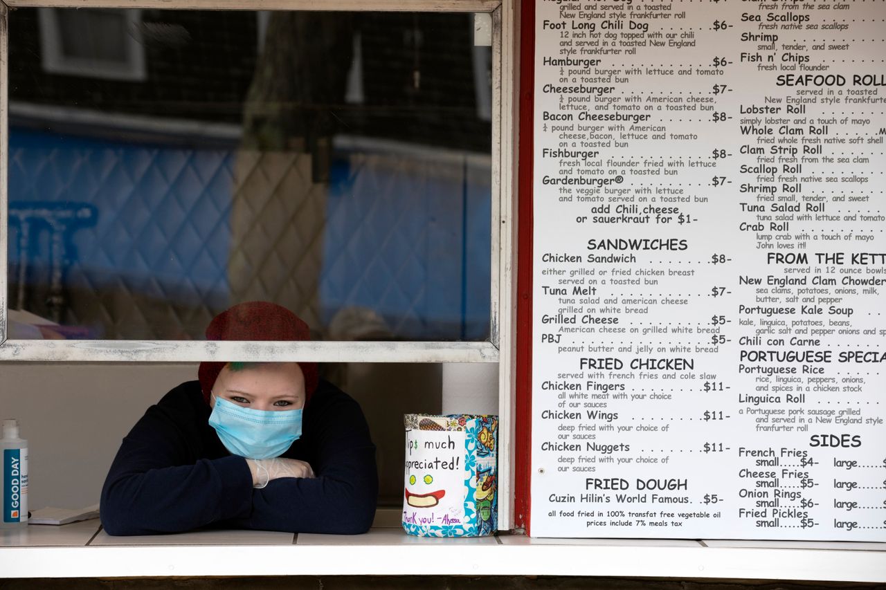 Alyssa Costa waits for customers at a takeout window on May 25 in Provincetown.