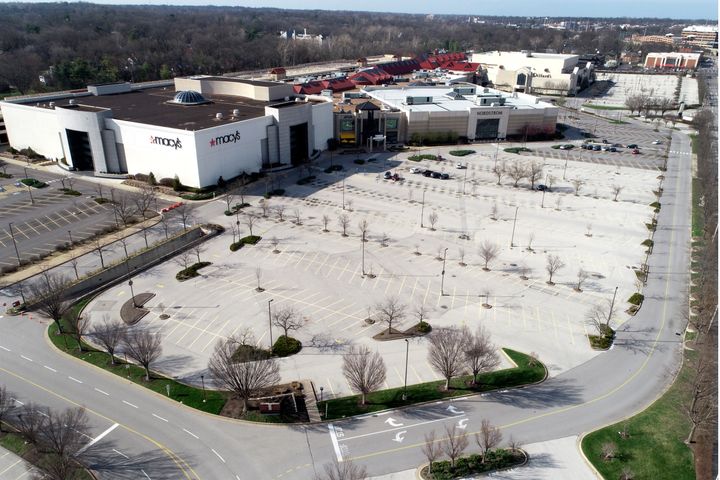 The parking lot surrounding Saint Louis Galleria mall is virtually empty Thursday, March 26, 2020, in Richmond Heights, Mo. (AP Photo/Jeff Roberson)