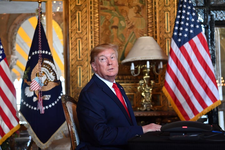 President Donald Trump answers questions from reporters after making a video call at his Mar-a-Lago estate in Palm Beach, Florida, in December 2019.