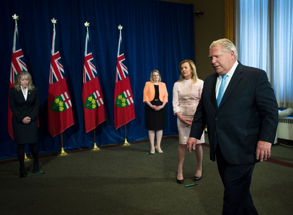 Ontario Premier Doug Ford leaves the podium after answering questions about a Canadian Armed Forces report that detailed disturbing conditions at long-term care homes in Toronto on May 26, 2020. 