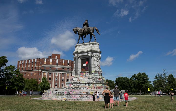 People visit a monument of Confederate general Robert E. Lee on June 5 after Virginia Governor Ralph Northam ordered its removal after widespread civil unrest.
