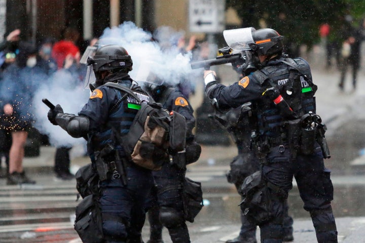 Washington State Police uses tear gas to disperse a crowd during a demonstration protesting the death of George Floyd, a black man who died May 25 in the custody of Minneapolis Police, turned destructive in Seattle, Washington on May 30, 2020. - Clashes broke out and major cities imposed curfews as America began another night of unrest Saturday with angry demonstrators ignoring warnings from President Donald Trump that his government would stop violent protests over police brutality "cold." (Photo by Jason Redmond / AFP) (Photo by JASON REDMOND/AFP via Getty Images)