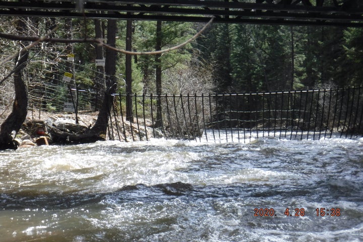 Fencing and razor wire are strung across the Pecos River on the Hersh property. "No Trespassing" signs hang on nearby trees.