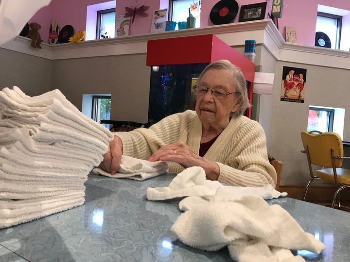 A resident folds towels in an undated photo at Sunnyside Home in Kitchener, Ont., where staff are working to change their approach to care.