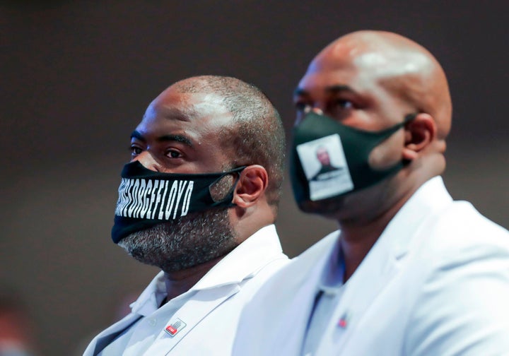 Brothers Rodney, left, and Philonise Floyd listen to the Rev. Al Sharpton as he gives the eulogy during the funeral service Tuesday for George Floyd in Houston.