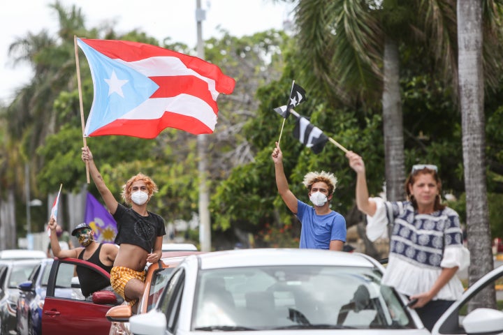 Demonstrators protest in front of the heavily guarded Capitol building in San Juan.